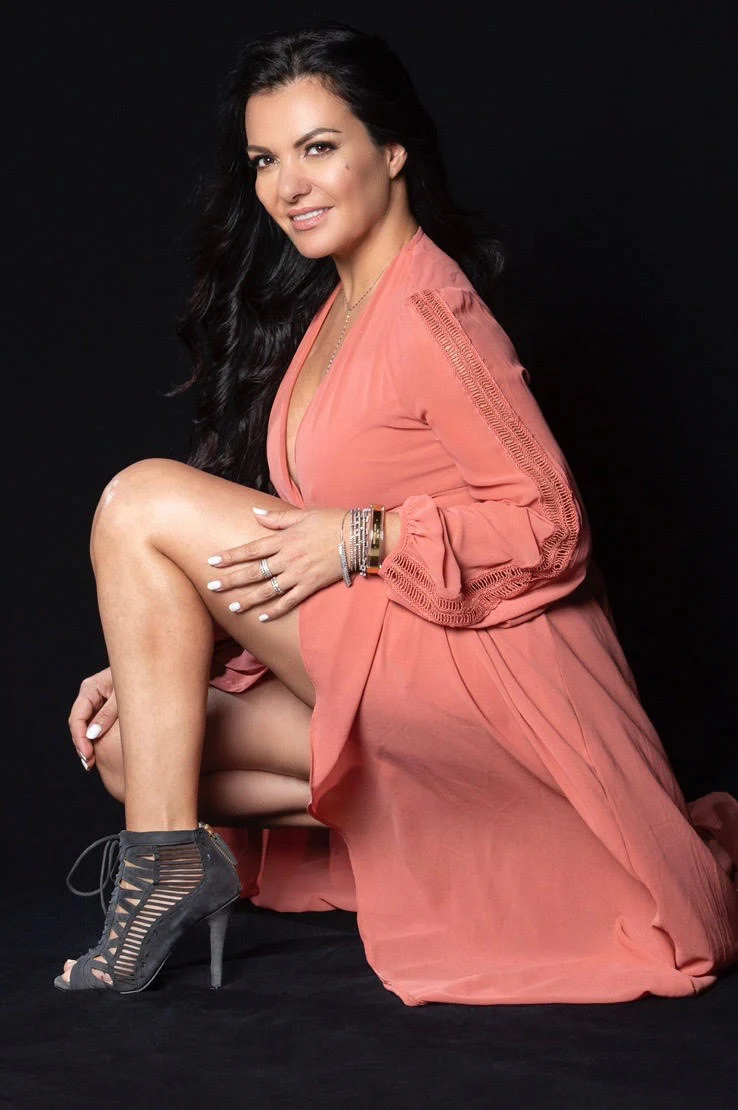 Patricia Avila seated against a black backdrop