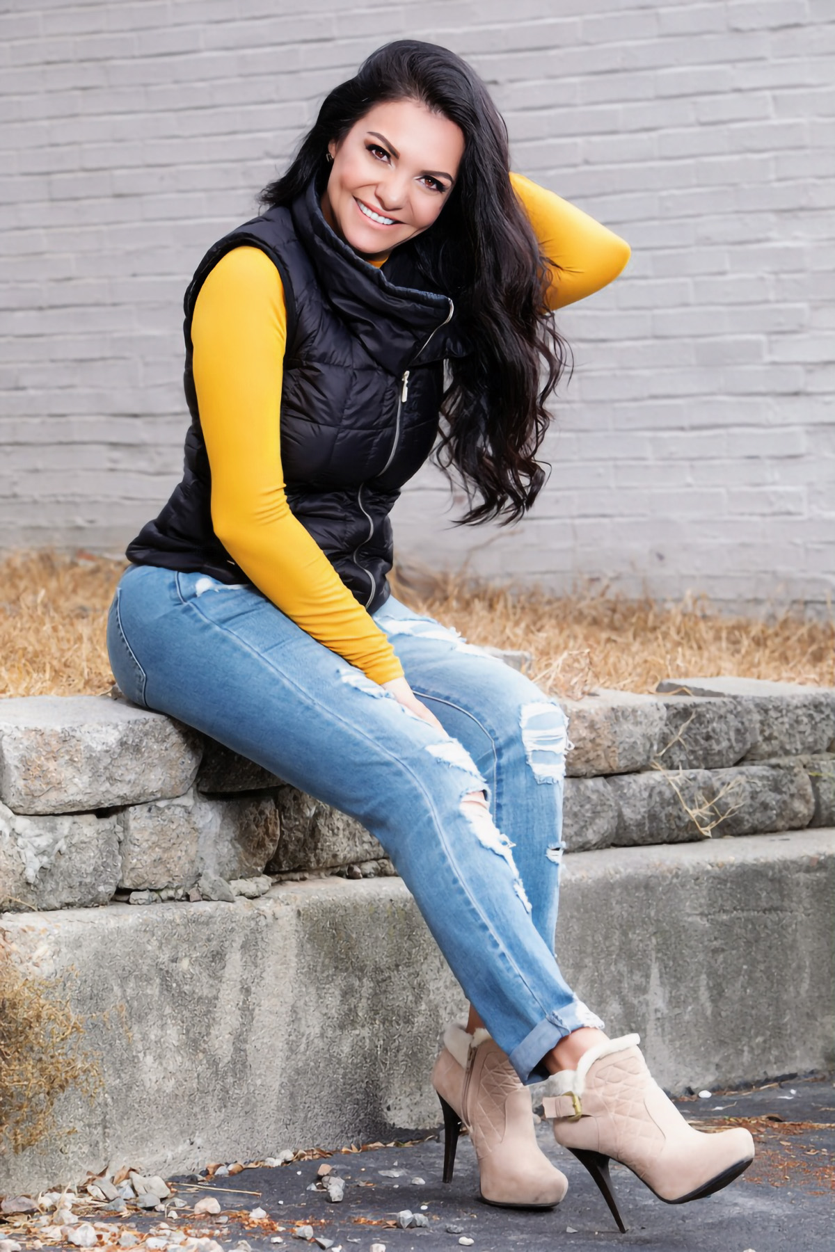 Patricia Avila seated on a stone ledge
